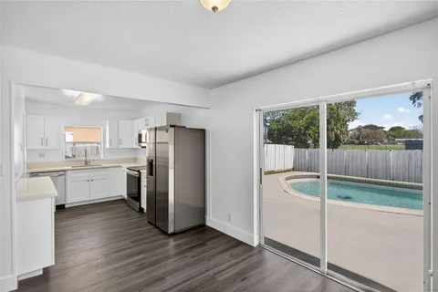 a kitchen with a refrigerator a sink and a cabinets