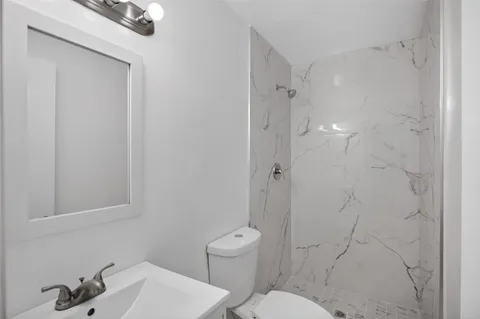 a bathroom with a toilet sink and shower
