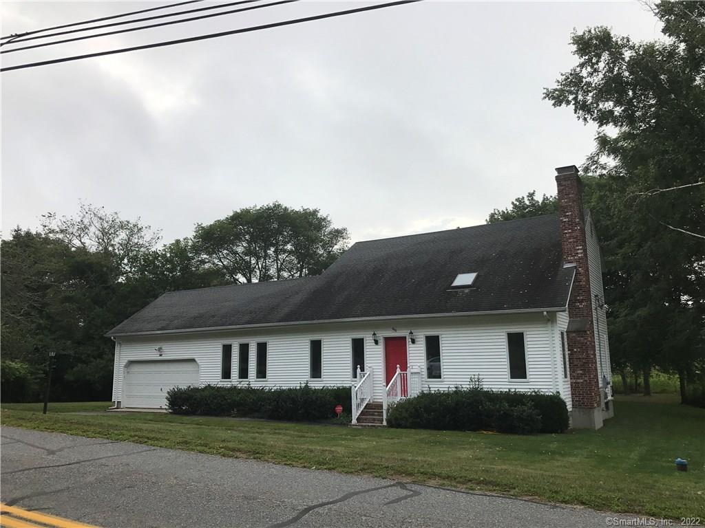 565 Greenhaven Road Stonington, CT 06379 - Photo 1 of 1 a front view of house with yard and trees in the background