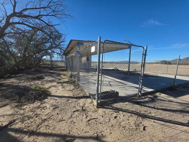 a view of a yard with wooden fence