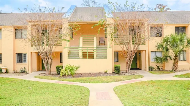 a view of a house with a backyard