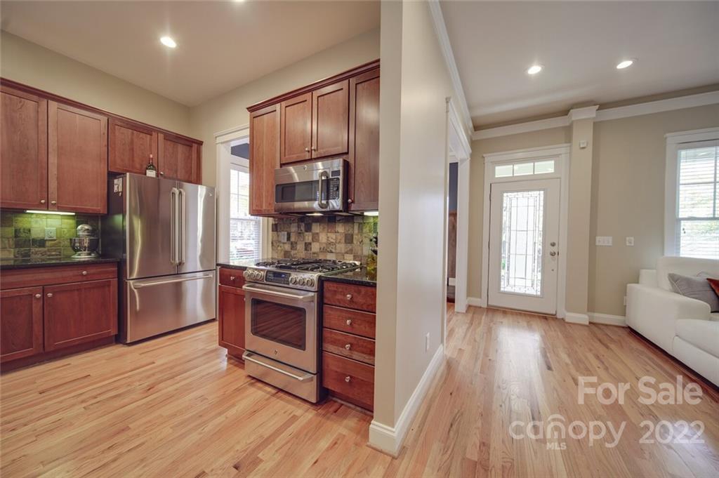220 Mills Lane Fort Mill, SC 29708 - Photo 13 of 42 a kitchen with stainless steel appliances a refrigerator and a stove top oven