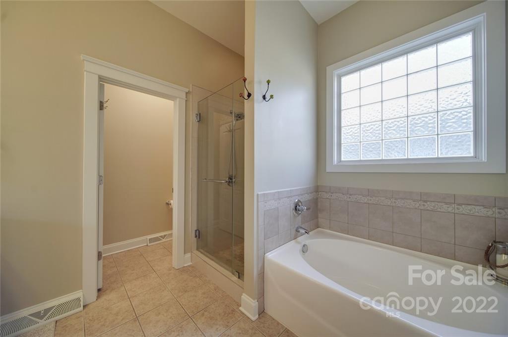 220 Mills Lane Fort Mill, SC 29708 - Photo 20 of 42 a bathroom with a bathtub and a shower