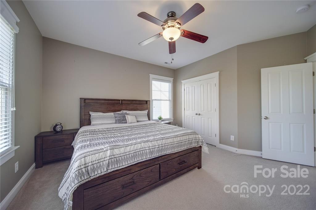 220 Mills Lane Fort Mill, SC 29708 - Photo 24 of 42 a bedroom with a large bed and a ceiling fan