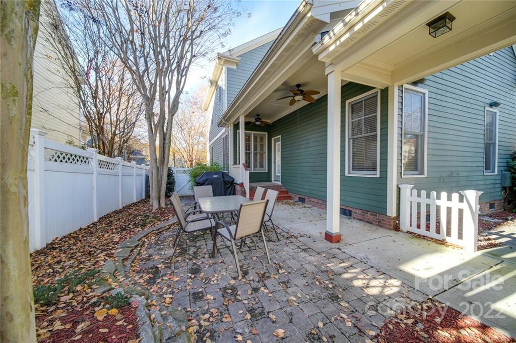 220 Mills Lane Fort Mill, SC 29708 - Photo 31 of 42 a view of a patio with table and chairs and wooden fence