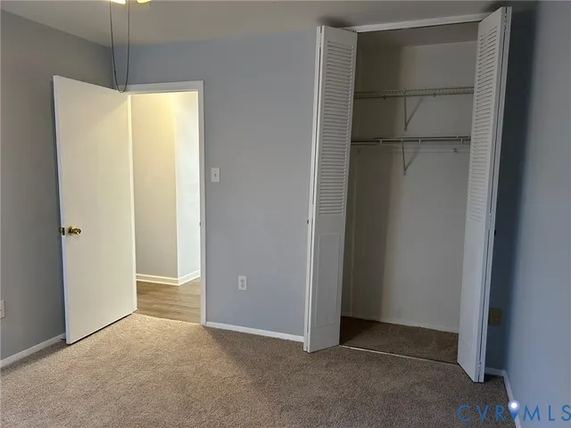a view of an empty room with a closet