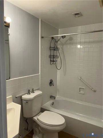 a bathroom with a toilet and shower