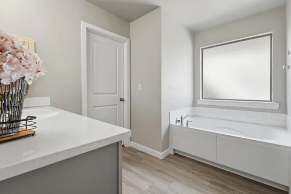a bathroom with a bathtub and a sink
