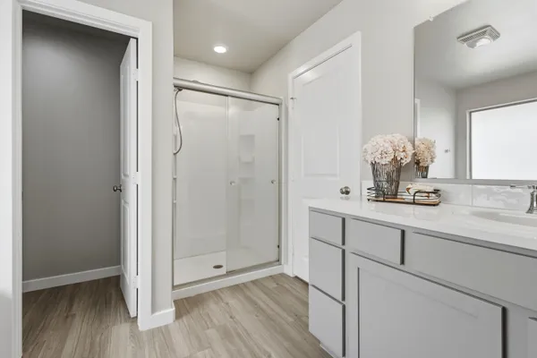 a bathroom with a mirror sink and shower