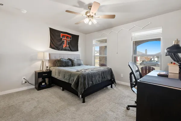 a bedroom with a bed and a chandelier