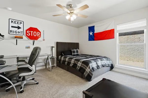 a bedroom with a bed and a bookshelf with a bookshelf