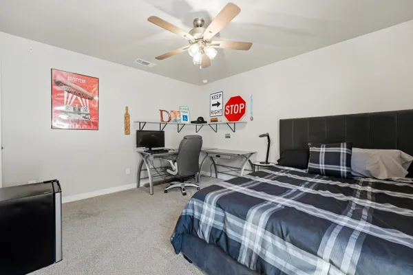 a bedroom with a bed and a chandelier