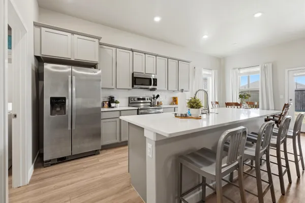 a kitchen with stainless steel appliances a refrigerator stove microwave and cabinets