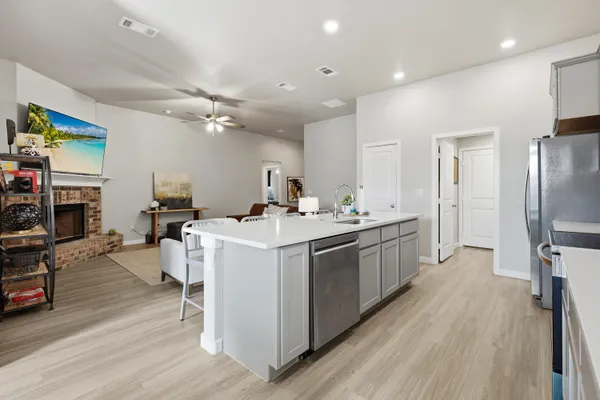 a kitchen with a sink appliances and cabinets