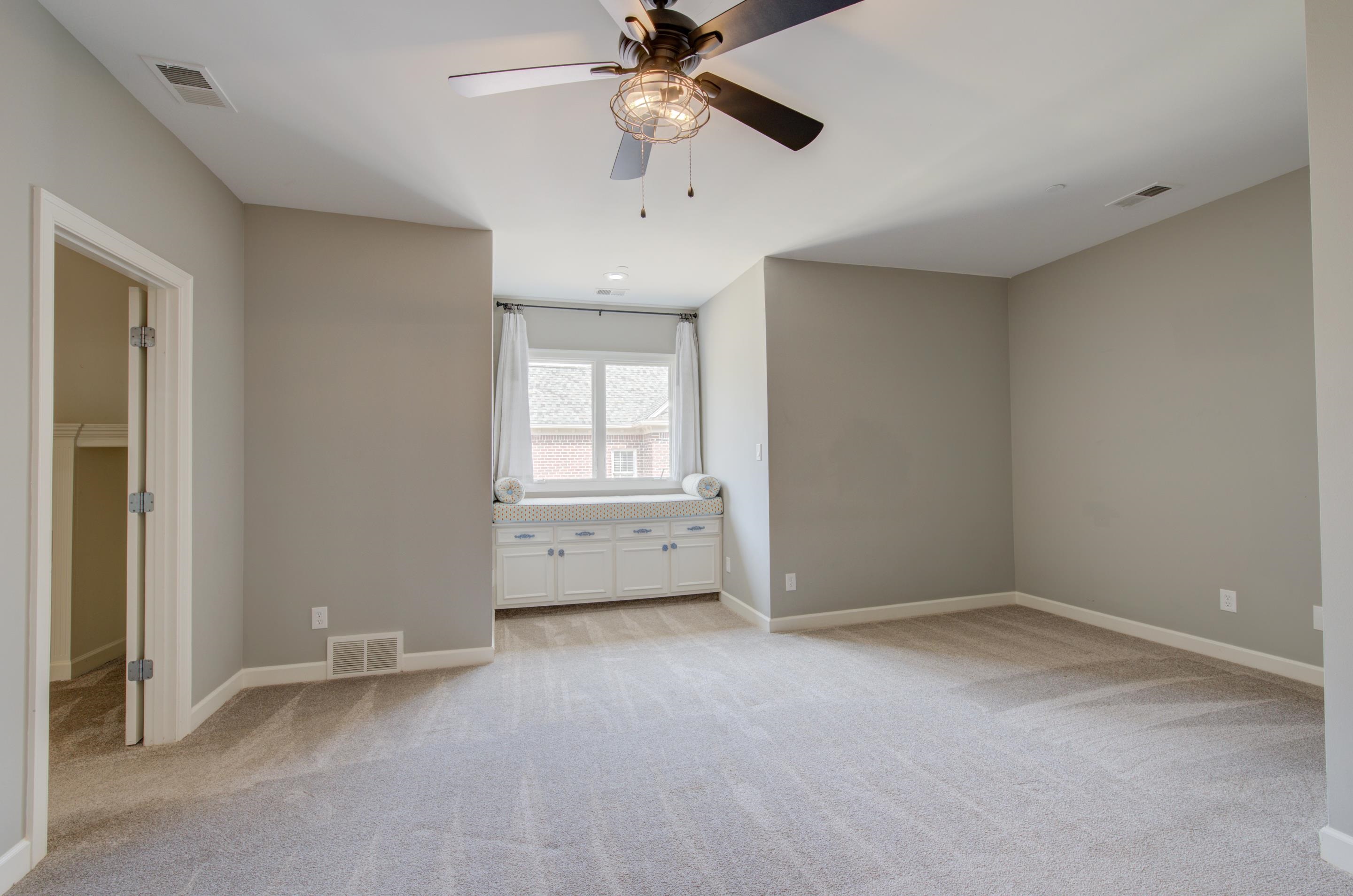 3474 Brooke Edge Lane Collierville, TN 38017 - Photo 18 of 25 an empty room with chandelier fan and windows