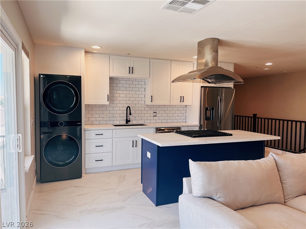 4631 Amazing View Street Las Vegas, NV 89129 - Photo 31 of 33 A well-appointed kitchen features a contrasting island and integrated laundry for seamless living.