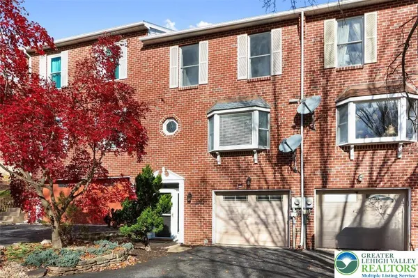 a front view of a house with large windows