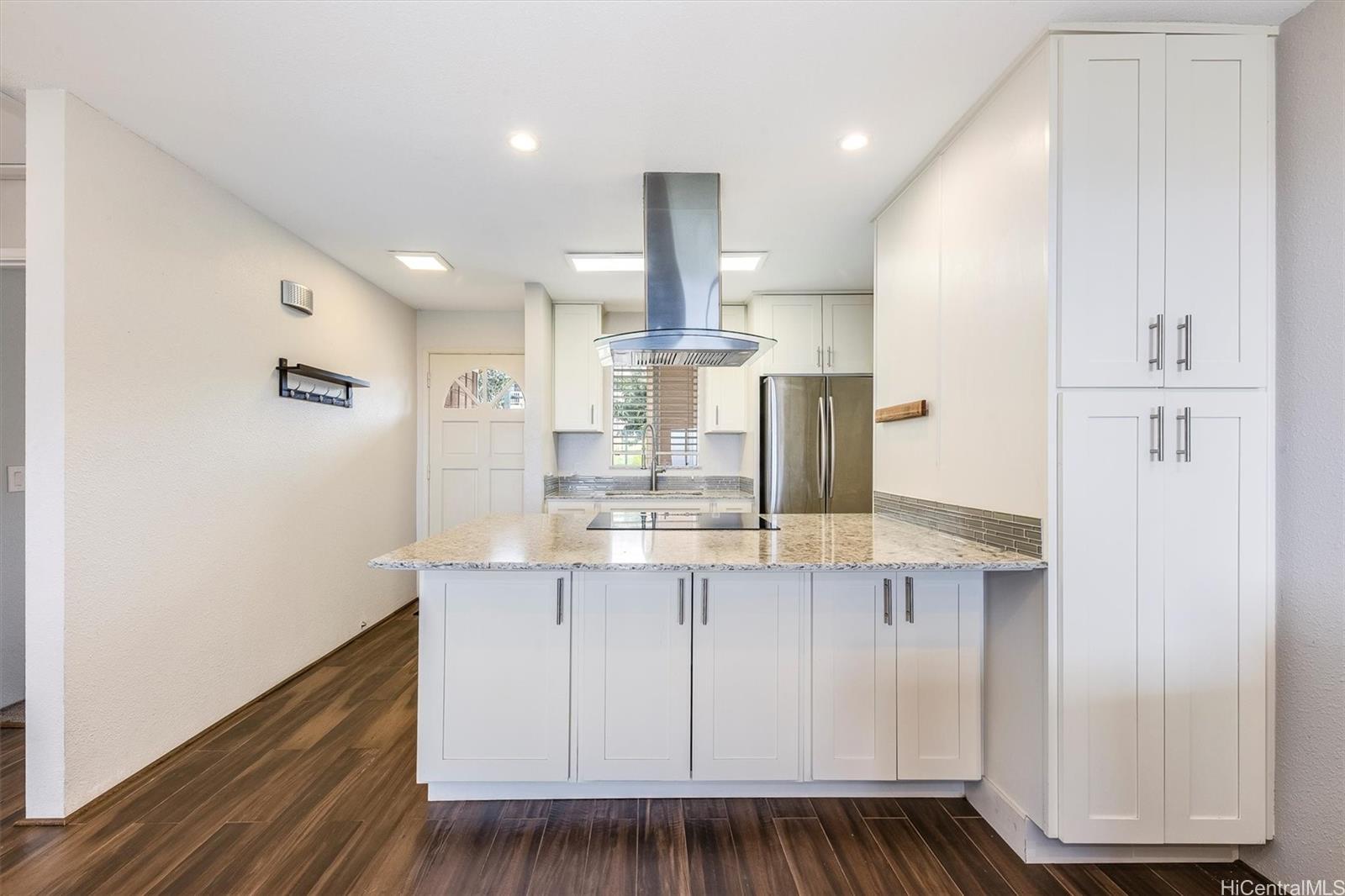a view of kitchen with granite countertop cabinets and wooden floor