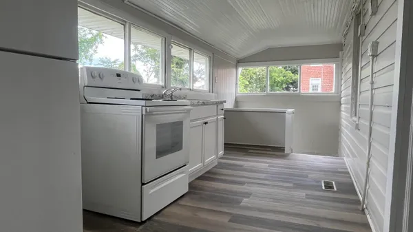 a kitchen with a stove a sink and a window