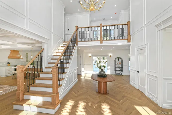 a view of entryway and hall with wooden floor