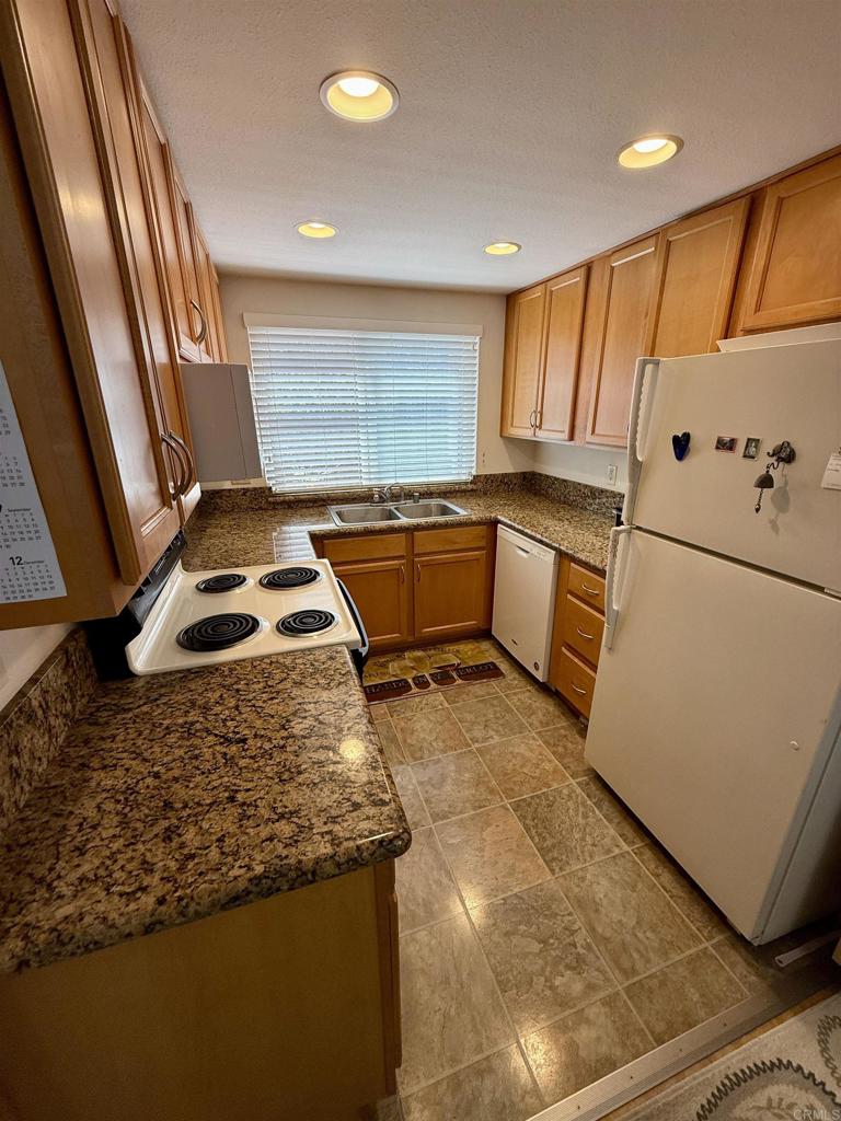 9575 Easter Way, Unit 5 San Diego, CA 92121 - Photo 3 of 19 a kitchen with a refrigerator and a window