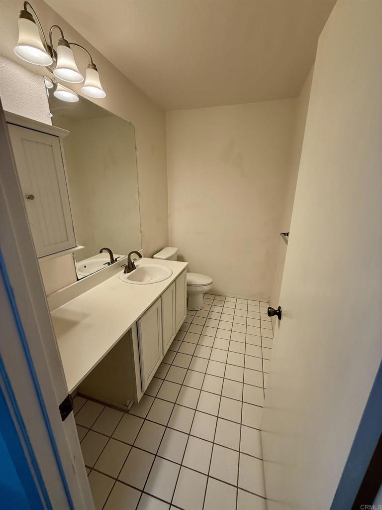9575 Easter Way, Unit 5 San Diego, CA 92121 - Photo 4 of 19 a bathroom with a sink a toilet and a mirror