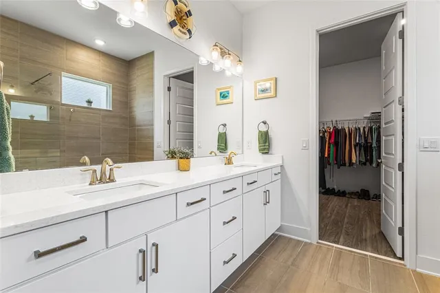 a spacious bathroom with a double vanity sink and mirror