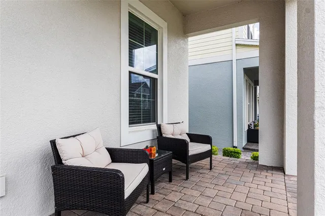 a living room with furniture and painting on the wall