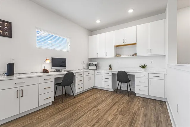 a kitchen with appliances a sink and cabinets