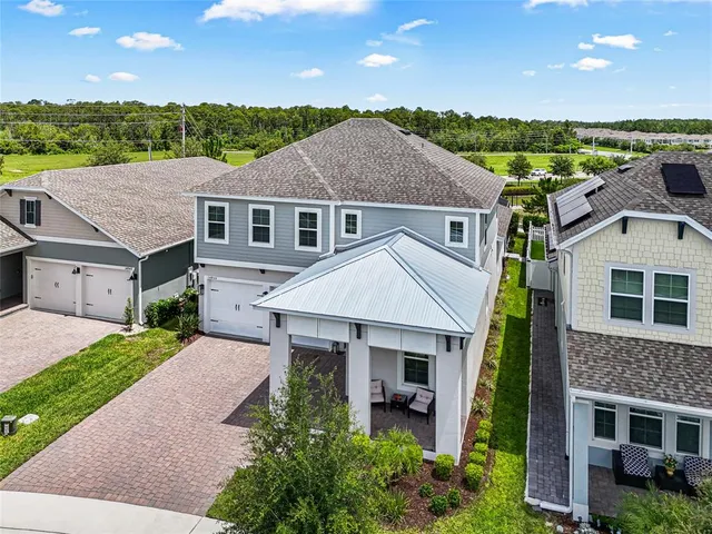 a aerial view of a house next to a yard