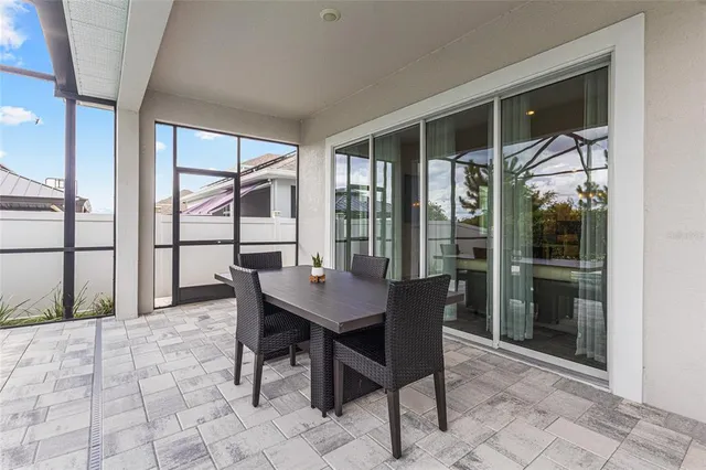 a view of a dining room with furniture large windows and wooden floor