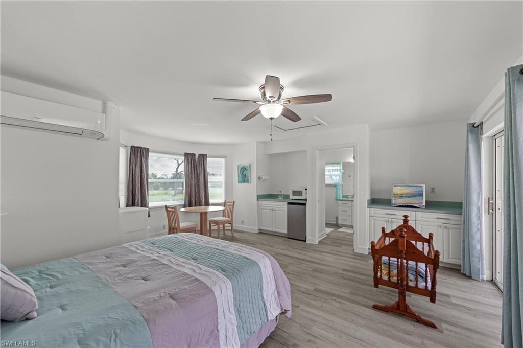 13541 Stringfellow Road Bokeelia, FL 33922 - Photo 27 of 49 a bed room with a bed and a chair