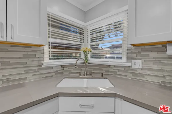 a kitchen with a sink and a window