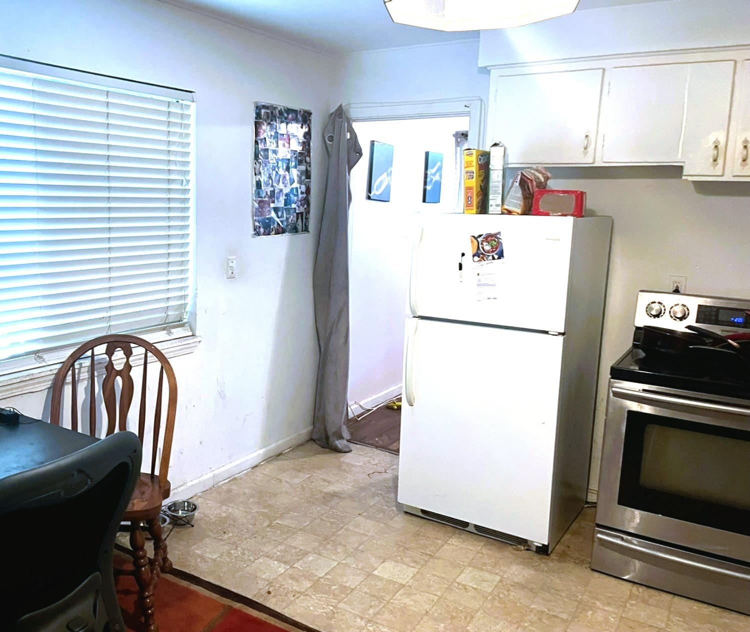 23 Second Street Marysville, CA 95901 - Photo 4 of 5 a white refrigerator freezer sitting in a kitchen