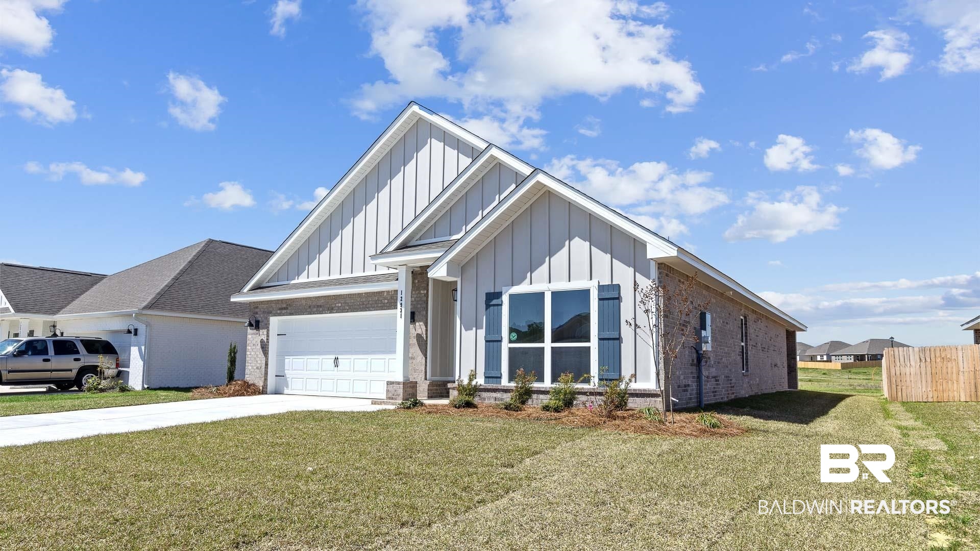12931 Grand Rpds Road Fairhope, AL 36532 - Photo 2 of 33 Modern farmhouse style home featuring brick siding, board and batten siding, concrete driveway, and a front lawn