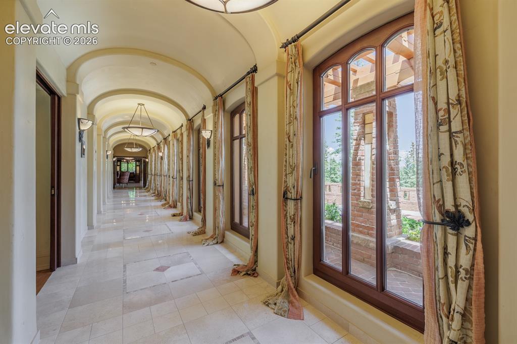 4530 Governors Point Colorado Springs, CO 80906 - Photo 21 of 49 Galleria hallway connecting the south and north wings of the home, alabaster custom lights
