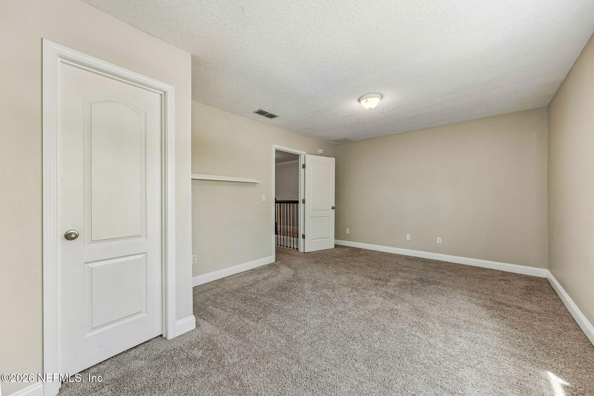 12198 Ridge Crossing Way Jacksonville, FL 32226 - Photo 42 of 67 an empty room with an entryway door