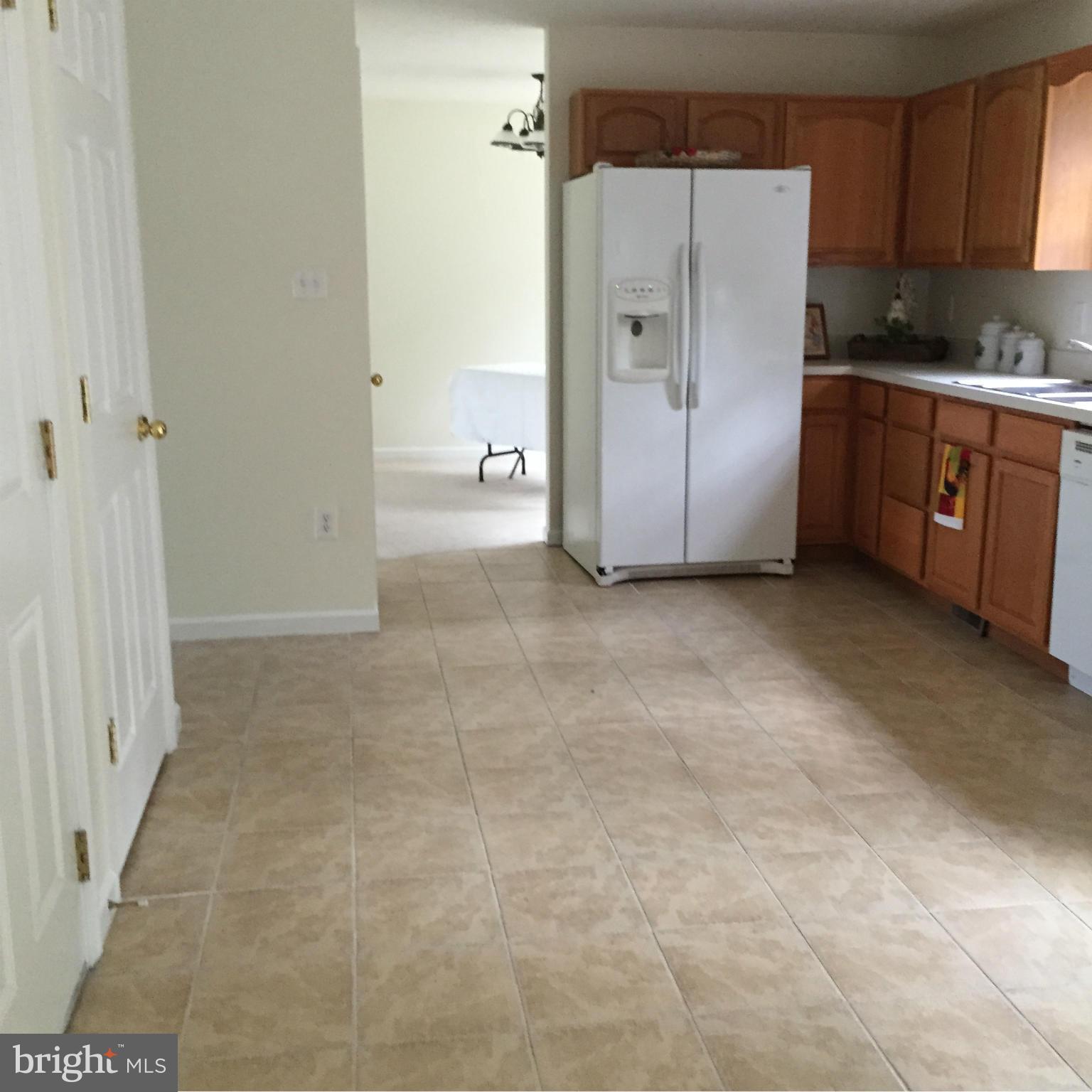 113 Gibson Road Inwood, WV 25428 - Photo 8 of 18 a kitchen with granite countertop a refrigerator and a stove