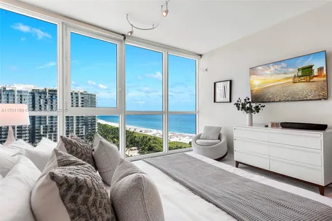 a living room with furniture and large window