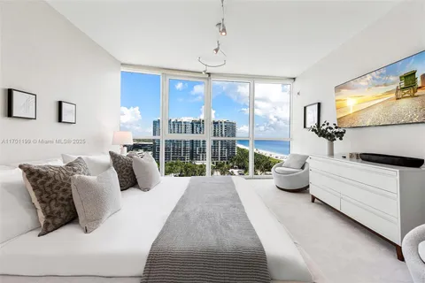 a living room with furniture large window and flat screen tv