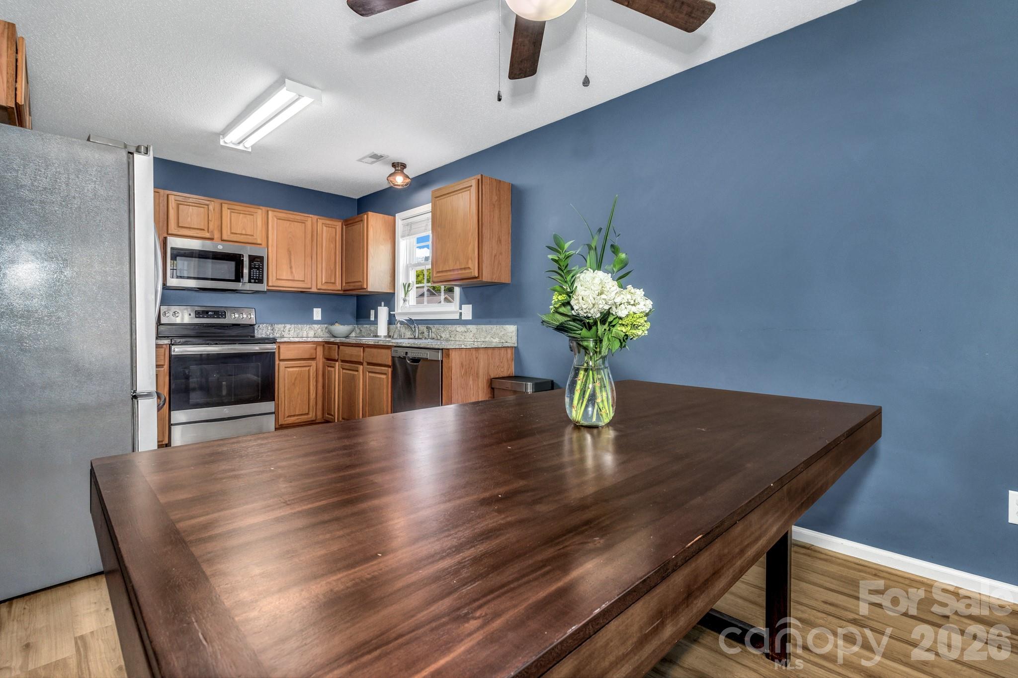 58 South Sunberry Trail Fletcher, NC 28732 - Photo 19 of 41 a dining room with furniture wooden floor and a kitchen view
