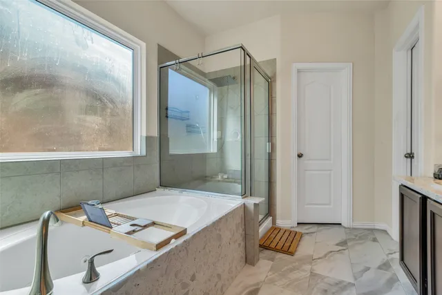a bathroom with a tub and a shower