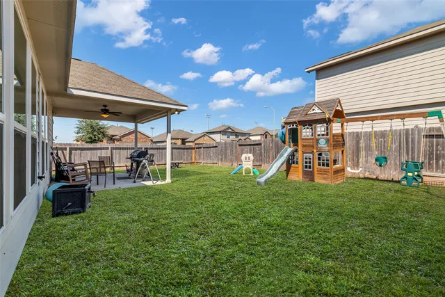 a view of a house with backyard and porch