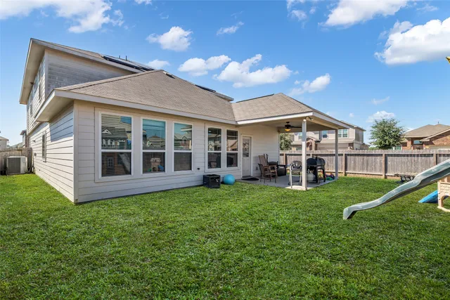 a view of house with yard and entertaining space