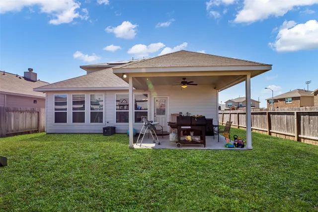 a view of a house with a backyard and patio