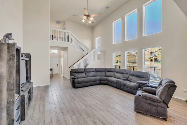 a living room with furniture and a wooden floor