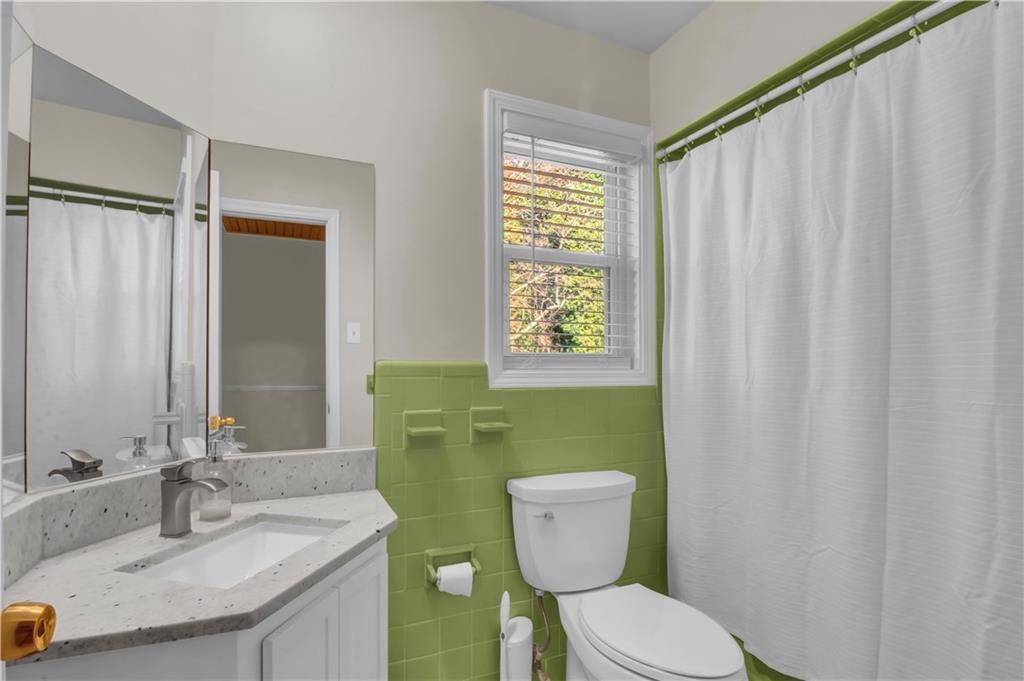3155 Hogan Road Southwest Atlanta, GA 30331 - Photo 11 of 15 a bathroom with a toilet a sink and a mirror