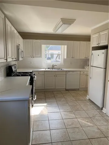 a kitchen with stainless steel appliances granite countertop a sink and a refrigerator
