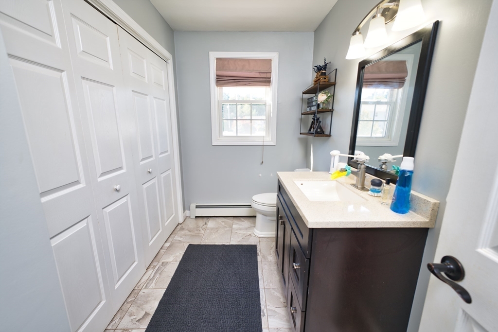 52 Pershing Avenue Acushnet, MA 02743 - Photo 12 of 27 a bathroom with a sink a toilet and a window