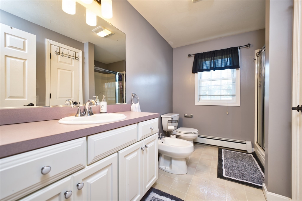 52 Pershing Avenue Acushnet, MA 02743 - Photo 15 of 27 a bathroom with a sink a toilet and a mirror